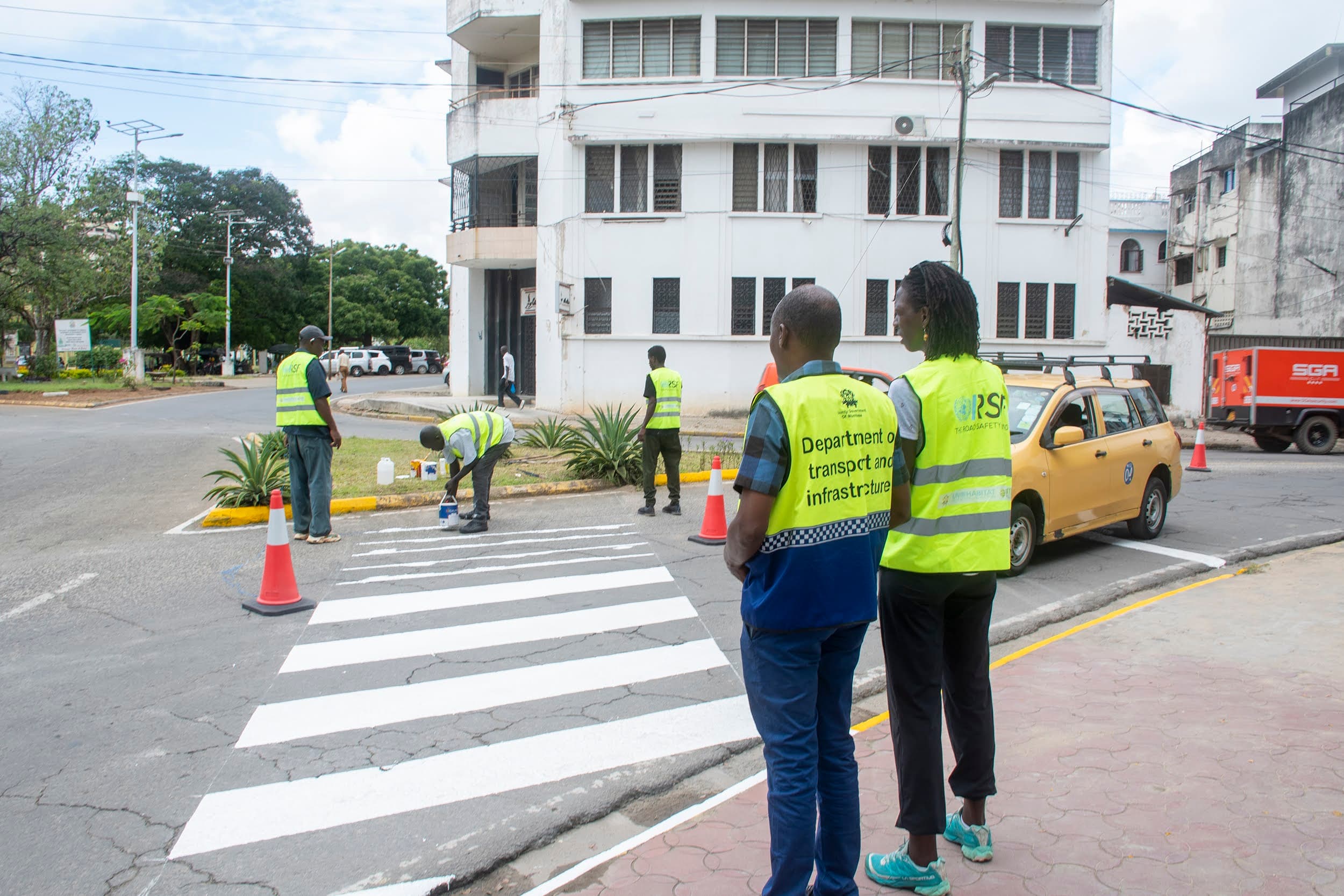 Road-safety personnel inspect a completed pedestrian crossing in Mombasa.